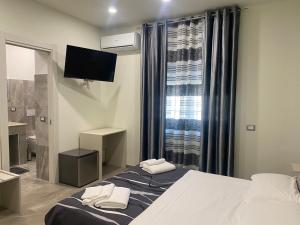 Posteľ alebo postele v izbe v ubytovaní Akoya Rooms Capo Vaticano
