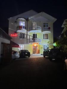 a building with cars parked in front of it at night at TEGI in Ureki