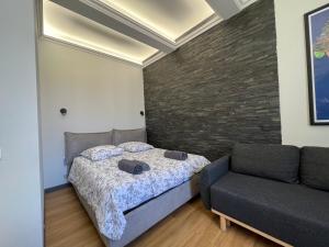 a bedroom with a bed and a couch at Newly Renovated Suite in the Center of Cannes in Cannes