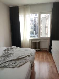 a bedroom with a bed and a large window at Our flat is located in Beşiktaş Square. in Istanbul