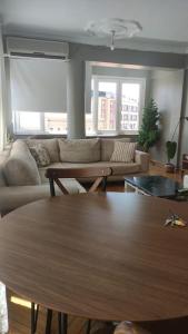 a living room with a table and a couch at Our flat is located in Beşiktaş Square. in Istanbul