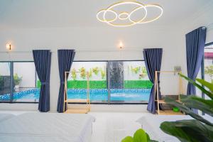 a bedroom with a pool seen through the windows at LP Villa 51 - Free Karaoke - Bida - Gần Bãi Sau in Vung Tau
