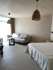 a living room with a bed and a couch at STUDIO 33 South Pearl in Sozopol