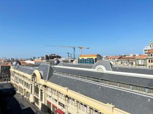 a train station with a train on the tracks at YOUROPO - Downtown in Porto