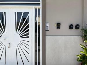 a glass door with a sunburst design on it at Manfredi Apartments in Torre Annunziata
