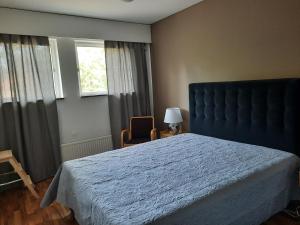 a bedroom with a large bed and a window at Family House Kupittaa Diplomat, Sauna, Garden, whole house for you in Turku
