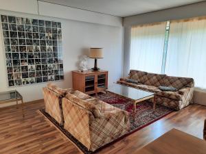 a living room with two couches and a coffee table at Family House Kupittaa Diplomat, Sauna, Garden, whole house for you in Turku +27 photos