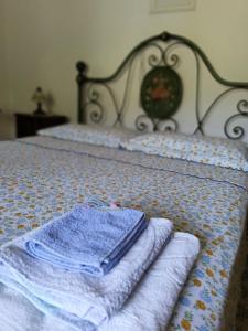 a bed with two towels sitting on top of it at Casa Le Piane in Strettura