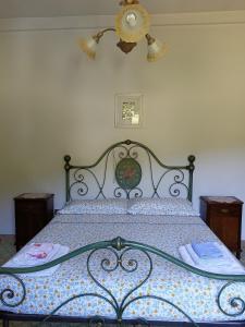 a bedroom with a bed with a wrought iron frame at Casa Le Piane in Strettura