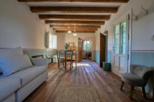 a living room with a couch and a table at Il Glicine - Natural BnB in Castello di Godego