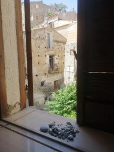 an open window with a view of a building at Revibe Art Recidence in Scalea