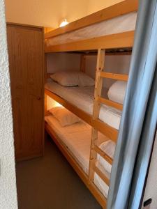 a bunk bed room with several bunk beds in it at Samoëns 1600 studio au pied des pistes in Samoëns