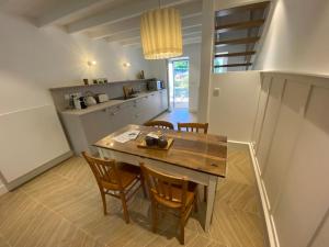 a kitchen with a wooden table and chairs at Lac's Lodge ¤ Maison coquette à 10min du lac in Annecy