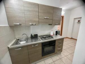 a kitchen with a sink and a stove at Minihome apartment in Catania