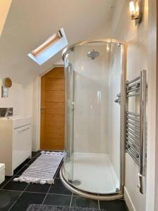 a bathroom with a shower with a glass enclosure at Roselands 