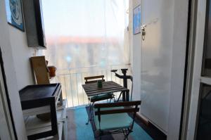 a kitchen with two chairs and a table and a window at PollyHouse - Apartment in Turin