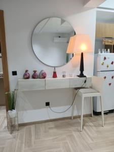 a white dressing table with a lamp and a mirror at Lovely apartment in Monastir in Monastir
