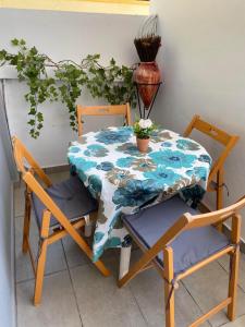 a table with two chairs and a table with a table cloth at Magio House in Ixia