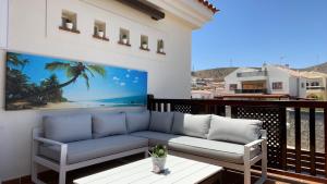 a living room with a couch on a balcony at Selena Luxury Monte Carrera in La Playa de Arguineguín