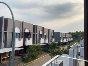 a row of buildings on a city street at 2BR HOUSE Happystay at FREJA BSD lalerooms close to ICE BSD find us on ig lalerooms in Tangerang
