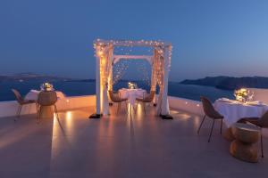 a set up for a wedding with tables and chairs at Aspaki by Art Maisons in Oia
