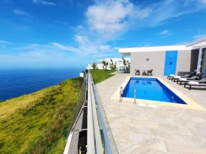 uma casa com piscina junto ao oceano em Villa Céu e Mar em Prazeres