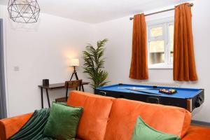 a living room with a couch and a pool table at Amazing 4BR Near Hospital, Free Parking, Sleeps 10 in Laindon