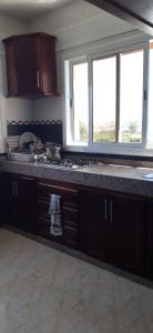 a kitchen with a counter top and two windows at Appartements Armonía Sea View in Briech
