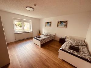 a room with two beds and a window at Villa 12 in Ketzin