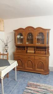 a wooden cabinet with glass doors in a room at Gästeapartment Brachelen in Hückelhoven