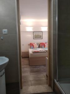 a small bedroom with a bed and a bathroom at Apartments and rooms Bova in Baška +63 photos