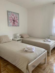 a room with two beds with towels on them at Apartman Loni , Belišće in Belišće