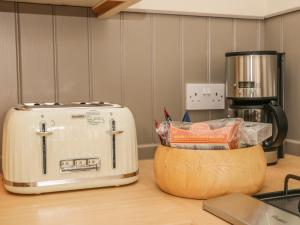 a toaster sitting on a counter next to a coffee maker at The Old School House in Scarborough