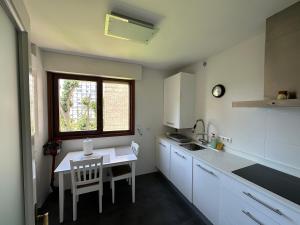 Apartamento Los Chopos في سانتاندير: مطبخ صغير مع طاولة ونافذة