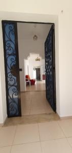 an open door to a room with a living room at Chouette villa au bord de la plage hergla in Sousse