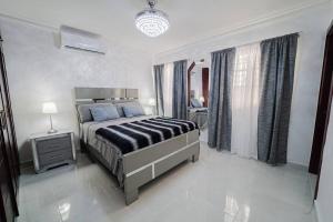 ein Schlafzimmer mit einem großen Bett in einem weißen Zimmer in der Unterkunft Luxury & Private Apartment in Mendoza