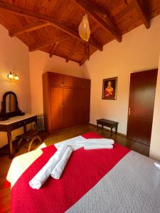 a bedroom with a large bed with red blanket at Villa Adonis with private pool by Lefkadastay in Lefkada Town