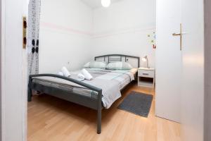 a bedroom with a bed in a white room at Rovinj Romance Apartment in Rovinj