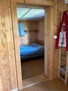 a small room with a bed in a wooden cabin at Beautiful Swiss chalet with breathtaking views and a sauna 