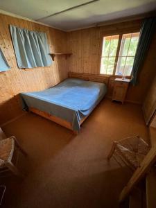 a bedroom with a bed in a wooden room at Beautiful Swiss chalet with breathtaking views and a sauna 