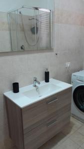 łazienka z umywalką i pralką w obiekcie Casa vacanza Luna w mieście Orte