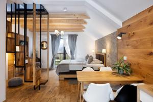 a bedroom with a bed and a table and chairs at Hiša Vally Art in Bled +25 photos