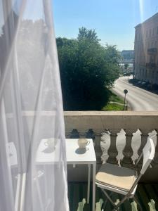 a table and a chair on a balcony at Danube Terrace Boutique Residence with private sauna in Budapest