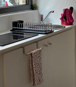 a kitchen counter with a sink and a towel at My Secret Room Apartment vicino al lago in Verbania