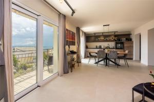a living room with sliding glass doors and a table with chairs at Apartment Vithea in Crikvenica