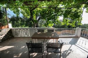 a patio with a table and chairs and a fence at Traditional stone house in Neokhórion