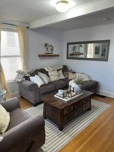 a living room with a couch and a coffee table at Farmhouse 2 bedrooms apartment in Lynn
