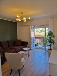 a living room with a couch and a table at Apartment with view on city marine in Zadar