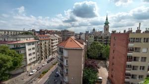 a view of a city with buildings and a clock tower at Buda Super Panorama in Budapest