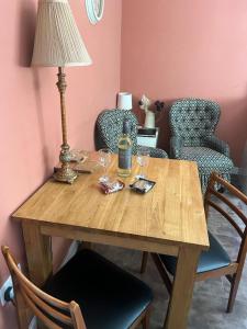 a wooden table with a lamp and two chairs at Laverick Steps in Whitby